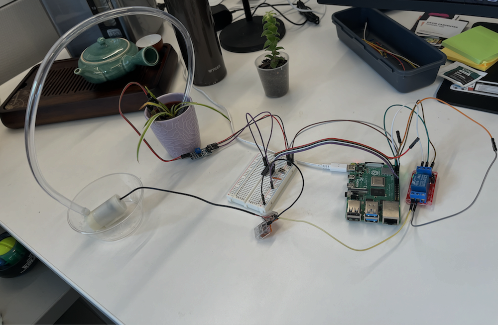 Picture of the plant watering machine on a desk.